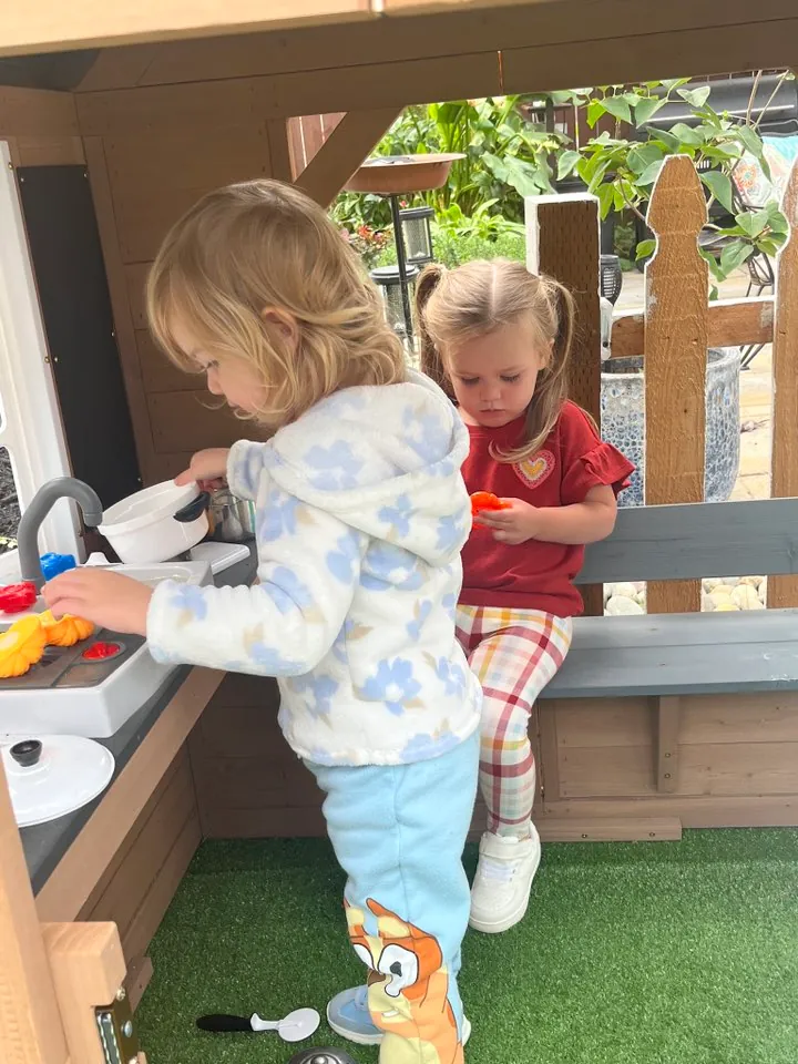 Children playing at the outdoor mud kitchen