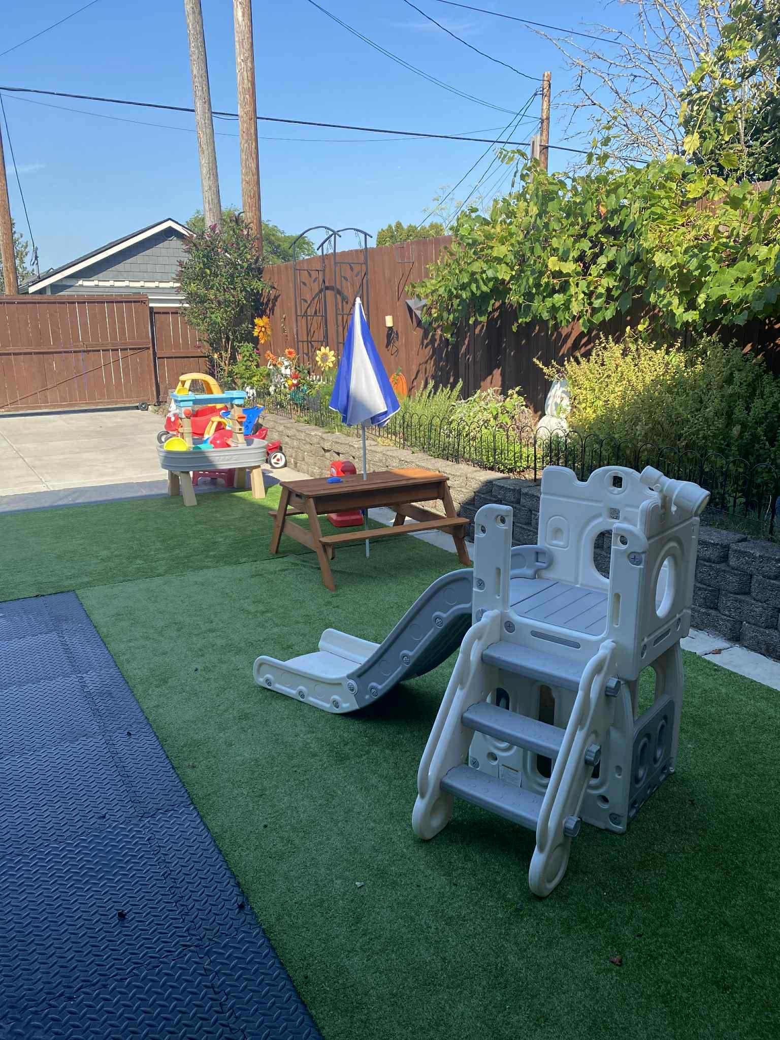 Outdoor play area with climbing equipment and sandbox