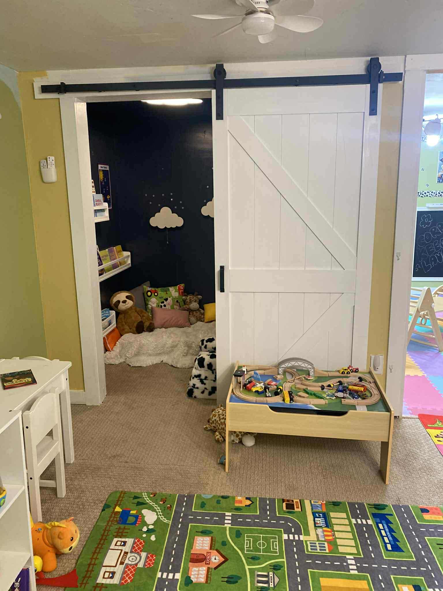 Cozy playroom with barn door and reading nook